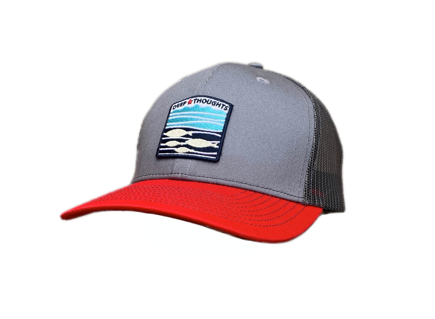 Grey red and charcoal trucker cap with embroidered red white and blue fish under waves patch