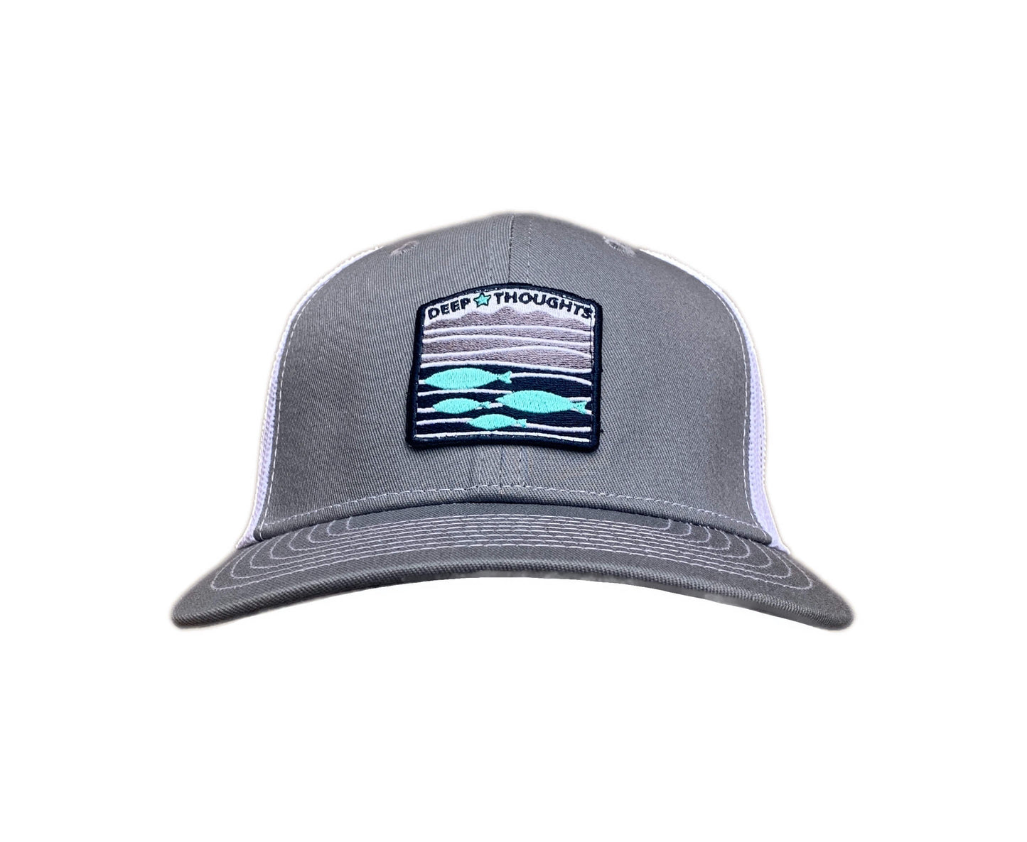 Front view of grey and white trucker cap with blue grey and white embroidered fish under waves patch