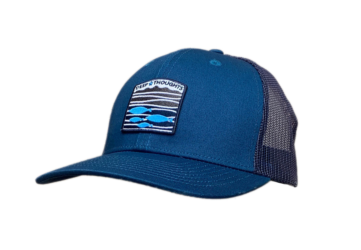 Teal and navy blue trucker cap with embroidered blue white and grey fish under waves patch